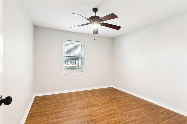 unfurnished room with hardwood / wood-style flooring and ceiling fan