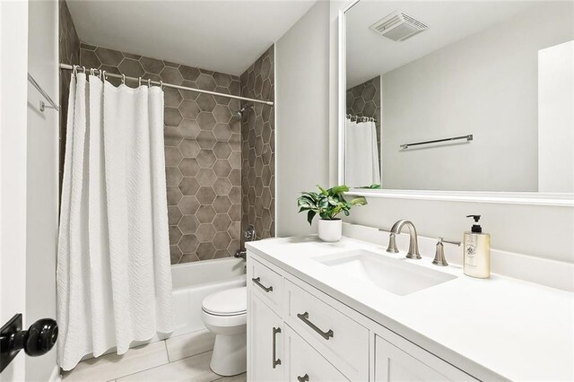 full bathroom featuring toilet, vanity, shower / bath combo, and tile patterned flooring