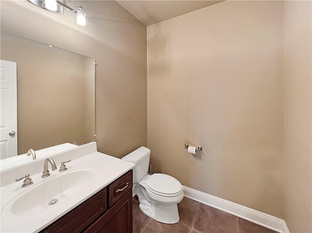 bathroom with vanity, toilet, and tile patterned flooring