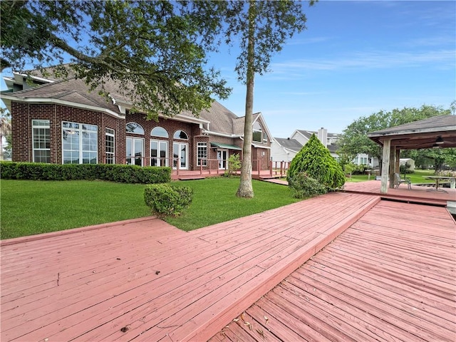 wooden terrace with a gazebo and a yard