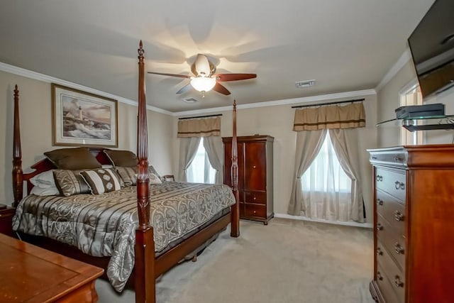 carpeted bedroom with ceiling fan and crown molding