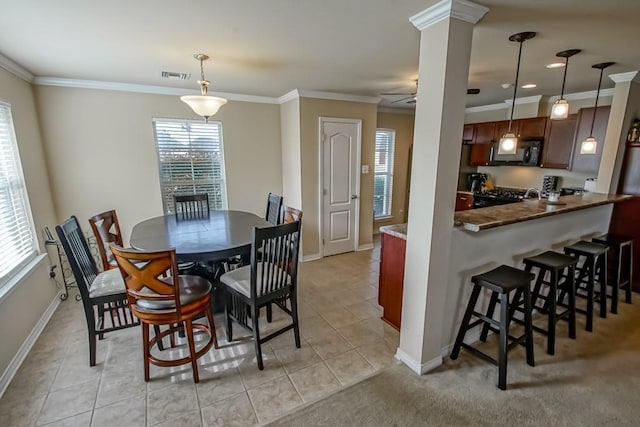 111 Judy Ct, Montz, LA 70068 - dining area with crown molding, light tile patterned floors, ceiling fan, and ornate columns