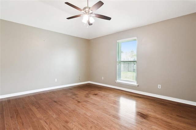 empty room featuring hardwood / wood-style floors and ceiling fan