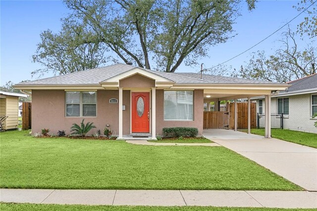 ranch-style house featuring a front yard and a carport