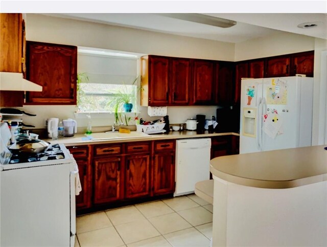 kitchen with sink, white appliances, and light tile patterned flooring