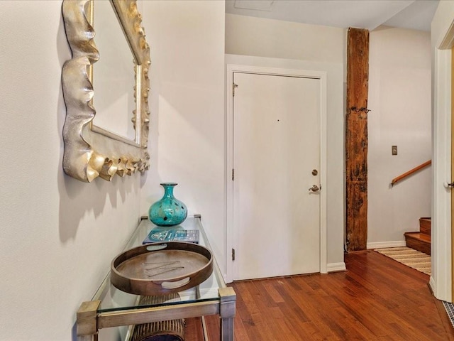 interior space featuring stairway, wood finished floors, and baseboards