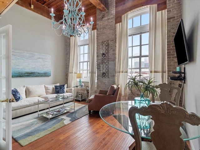 dining area with hardwood / wood-style flooring, plenty of natural light, and beam ceiling