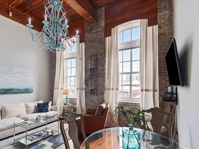 dining space with a chandelier, wooden ceiling, and beamed ceiling