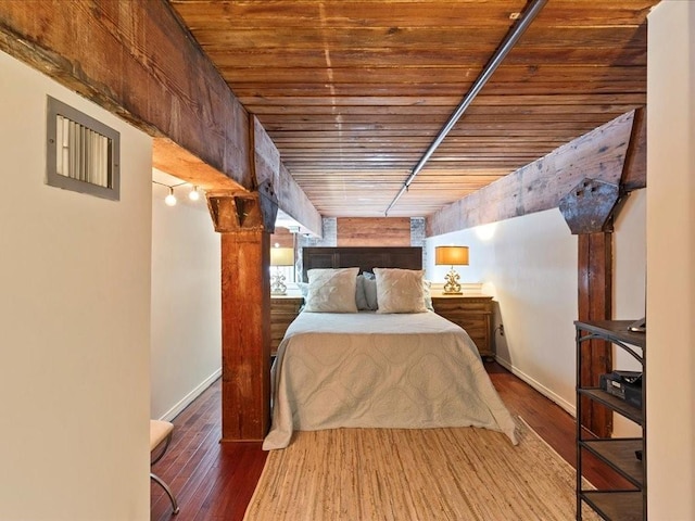 unfurnished bedroom featuring wood ceiling, baseboards, and wood finished floors