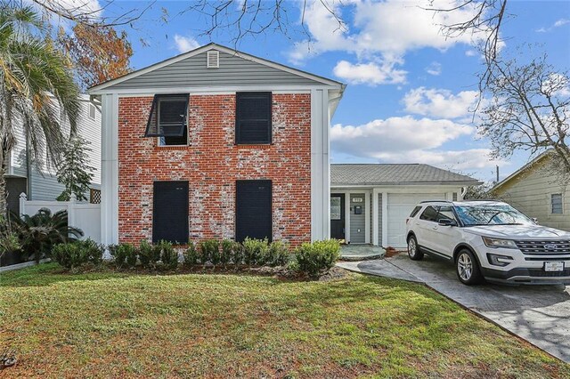 view of front of home featuring a garage and a front lawn