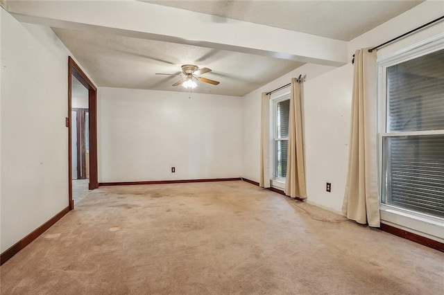 empty room featuring ceiling fan and light carpet