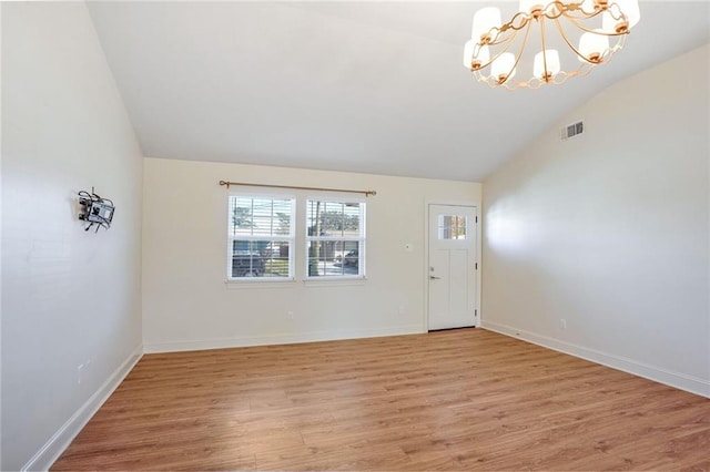 interior space featuring a chandelier, lofted ceiling, and hardwood / wood-style floors