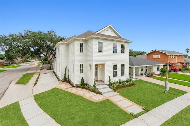 view of front of property featuring a front lawn and concrete driveway