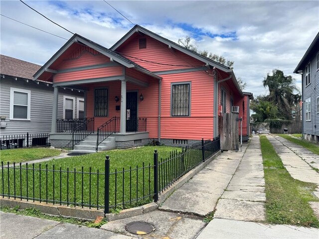 bungalow-style house featuring a front yard