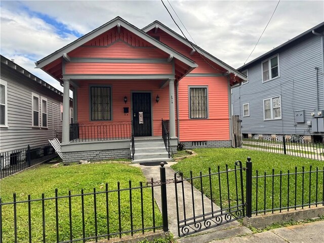 bungalow with a front lawn and covered porch