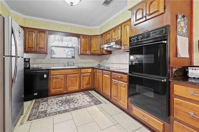 kitchen featuring black appliances, sink, crown molding, light tile patterned flooring, and a textured ceiling