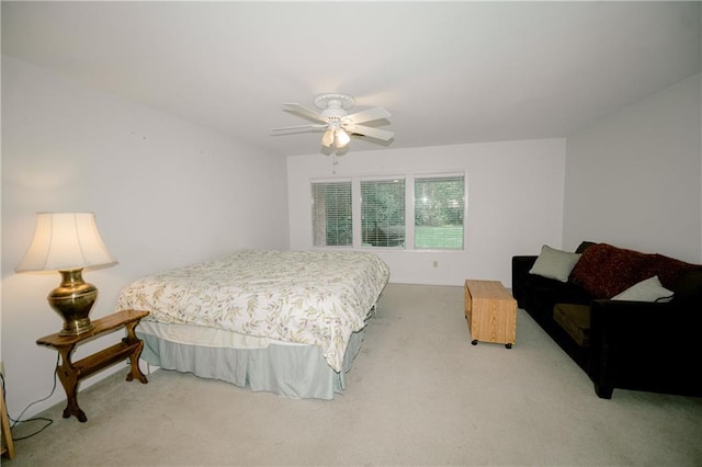 bedroom with ceiling fan and light carpet