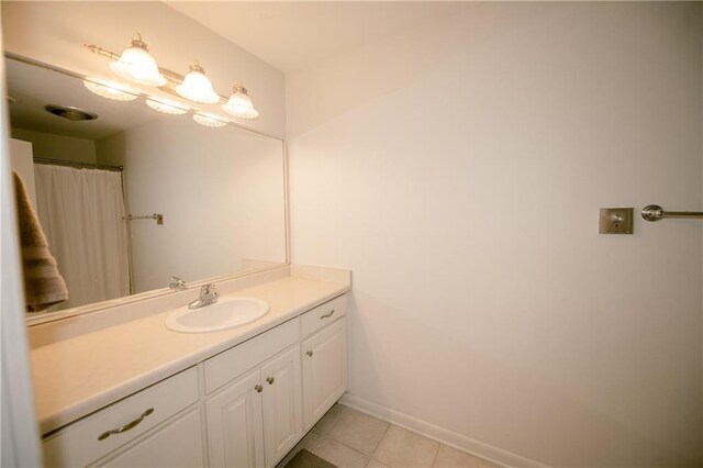 bathroom featuring tile patterned flooring and vanity