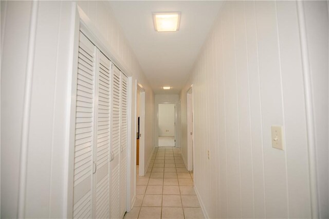 hall with light tile patterned floors