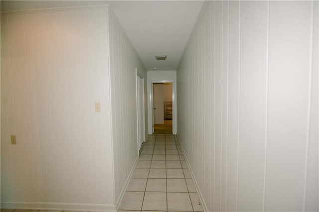 1005 W 5th St, Bogalusa, LA 70427 - hallway with wooden walls and light tile patterned flooring