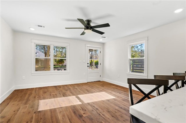 foyer with ceiling fan and light hardwood / wood-style floors