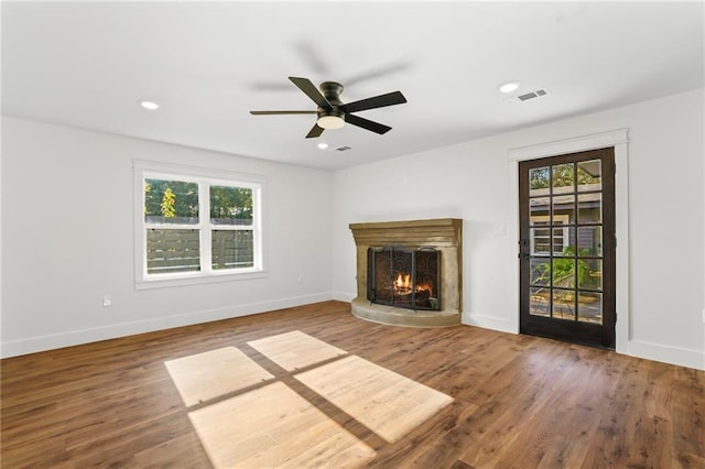 unfurnished living room with ceiling fan, hardwood / wood-style floors, and a healthy amount of sunlight