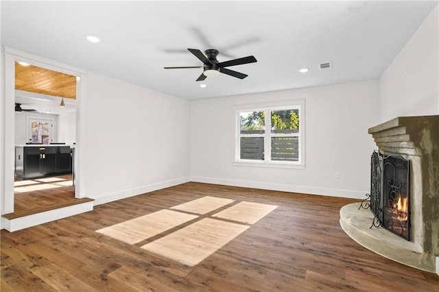 unfurnished living room featuring ceiling fan and dark hardwood / wood-style floors