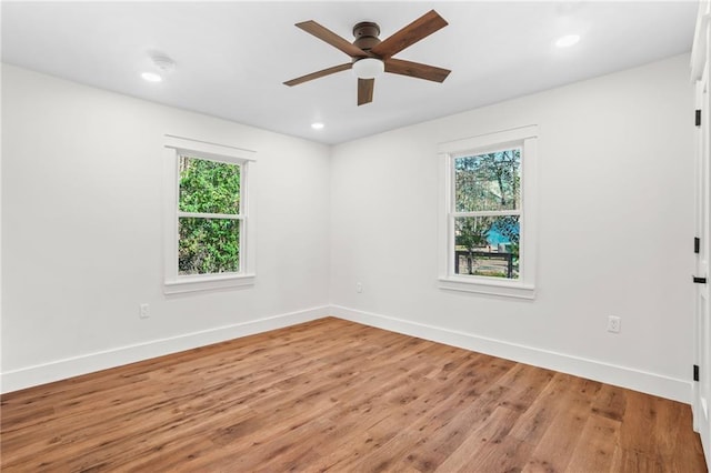 spare room with ceiling fan and wood-type flooring