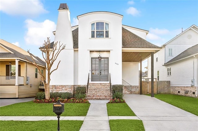 view of front of house featuring french doors and a front yard