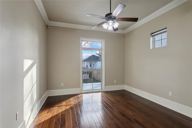 spare room featuring a healthy amount of sunlight, dark wood-type flooring, and ornamental molding