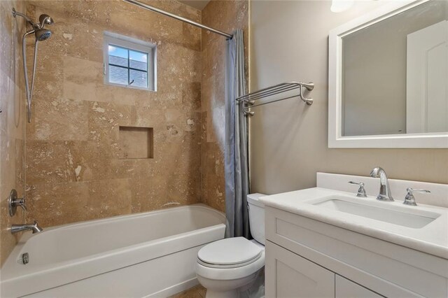 full bathroom with toilet, vanity, and shower / bath combo