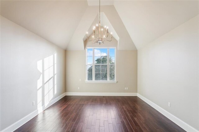 interior space with dark hardwood / wood-style flooring, lofted ceiling, and a notable chandelier