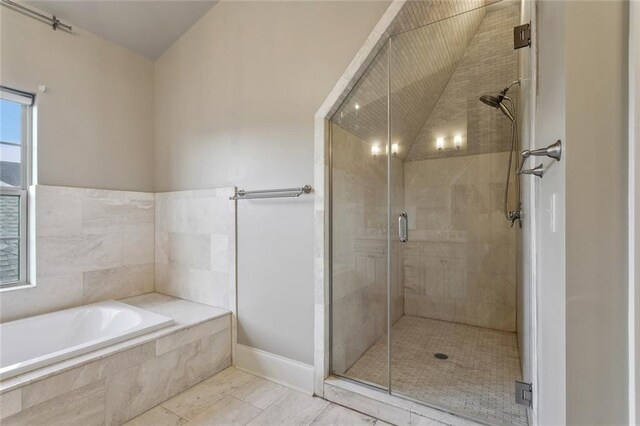 bathroom featuring shower with separate bathtub