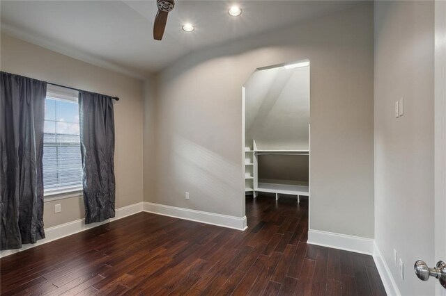 unfurnished room featuring ceiling fan and dark wood-type flooring