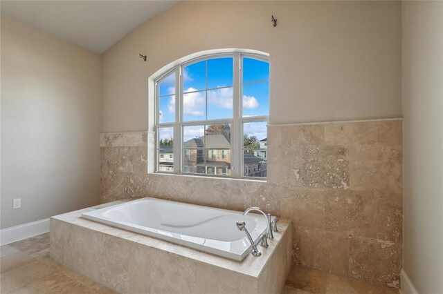 bathroom with tiled tub