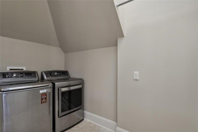 clothes washing area with separate washer and dryer