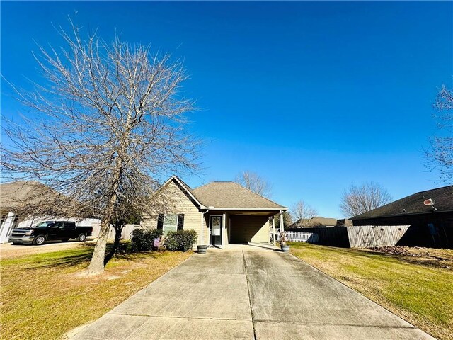 view of front of home with a front yard and a carport