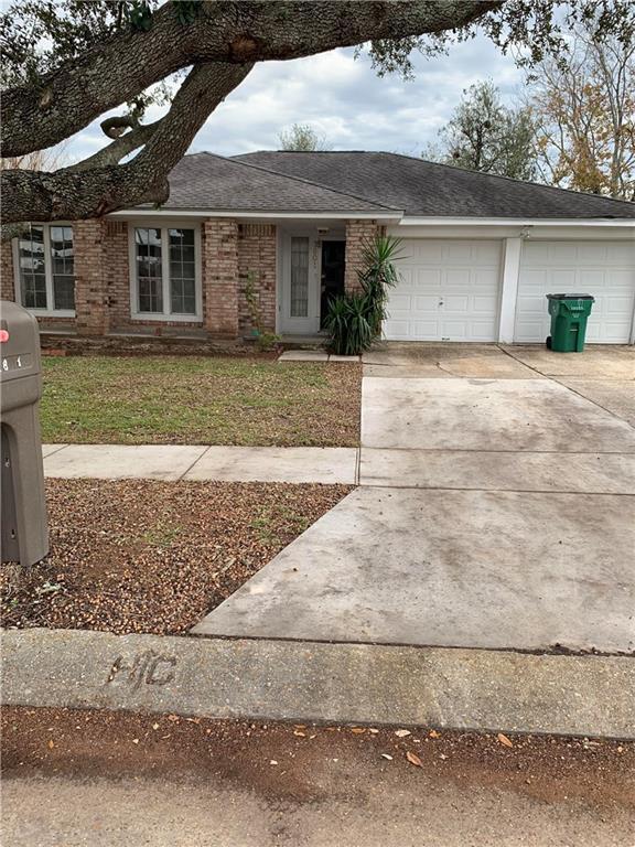 single story home with a front yard and a garage