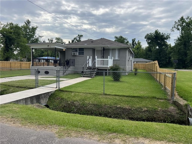 view of front of house featuring a front lawn and a carport