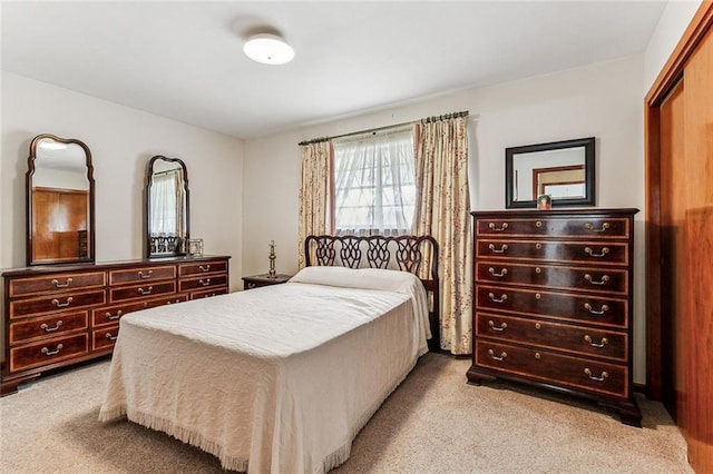 bedroom featuring light carpet