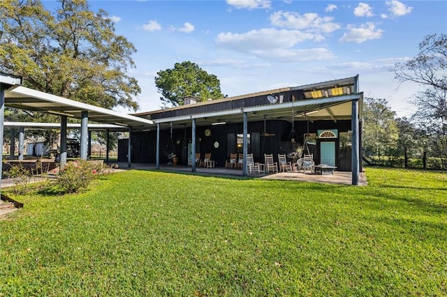 rear view of house featuring a lawn