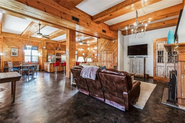 living room featuring ceiling fan with notable chandelier, wood walls, and beamed ceiling