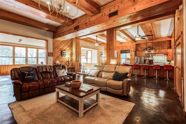 living room featuring ceiling fan, wood walls, and beamed ceiling