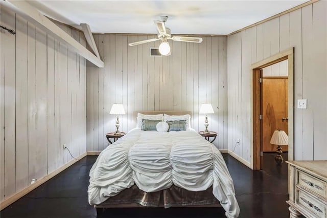 bedroom featuring ceiling fan and wooden walls