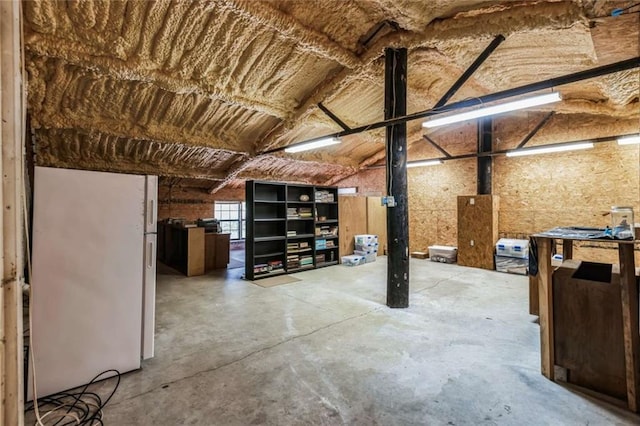 basement featuring white fridge