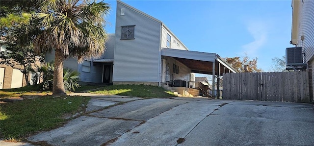 exterior space featuring cooling unit and a yard