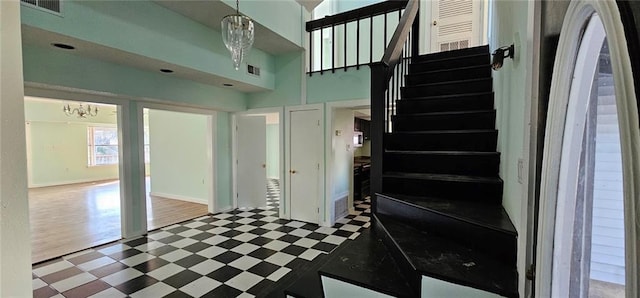 4410 San Remo Rd, New Orleans, LA 70129 - stairway with a chandelier and tile patterned floors