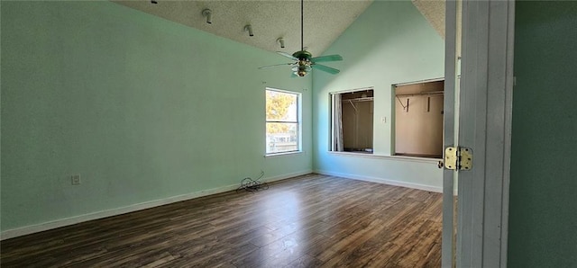 empty room featuring ceiling fan, a textured ceiling, dark hardwood / wood-style floors, and high vaulted ceiling