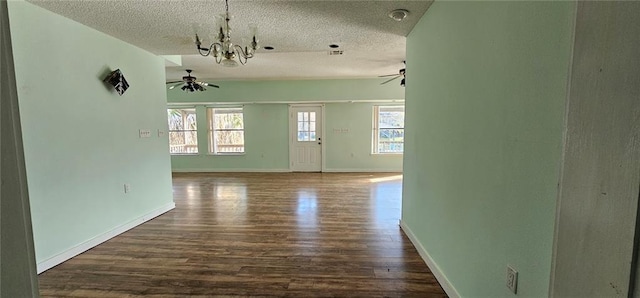 4410 San Remo Rd, New Orleans, LA 70129 - spare room with a ceiling fan, dark wood-type flooring, a textured ceiling, plenty of natural light, and a chandelier