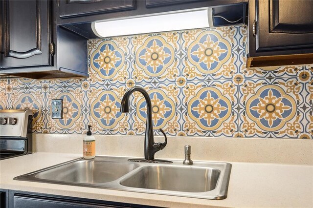 kitchen with backsplash, dark brown cabinets, and sink